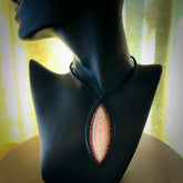 This photo shows a medium sized drop pendant hand carved from ebony with Mother of Pearl inlay alongside; copper and silver. This is a stand out one off necklace for those who appreciate art to wear. It is provided with a cord in black that is a fixed length with Paua Shell Toggle. We ship this piece worldwide and shipping is included in the price.